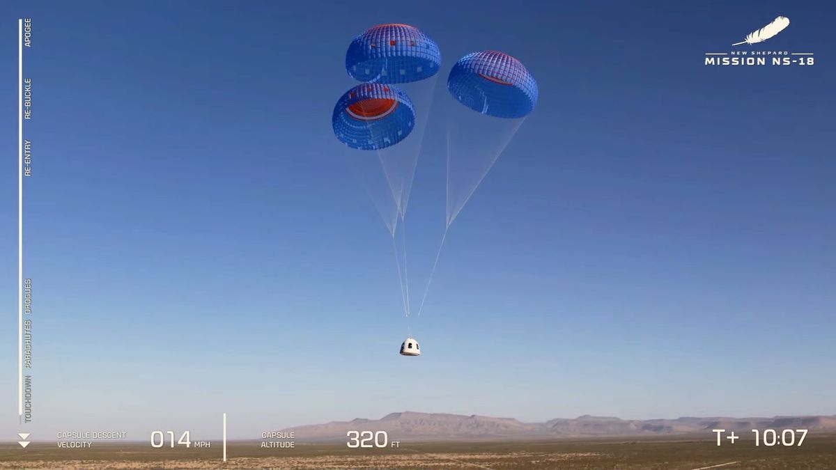 The NS-18 capusle and its chutes stand out against the clear West Texas sky.