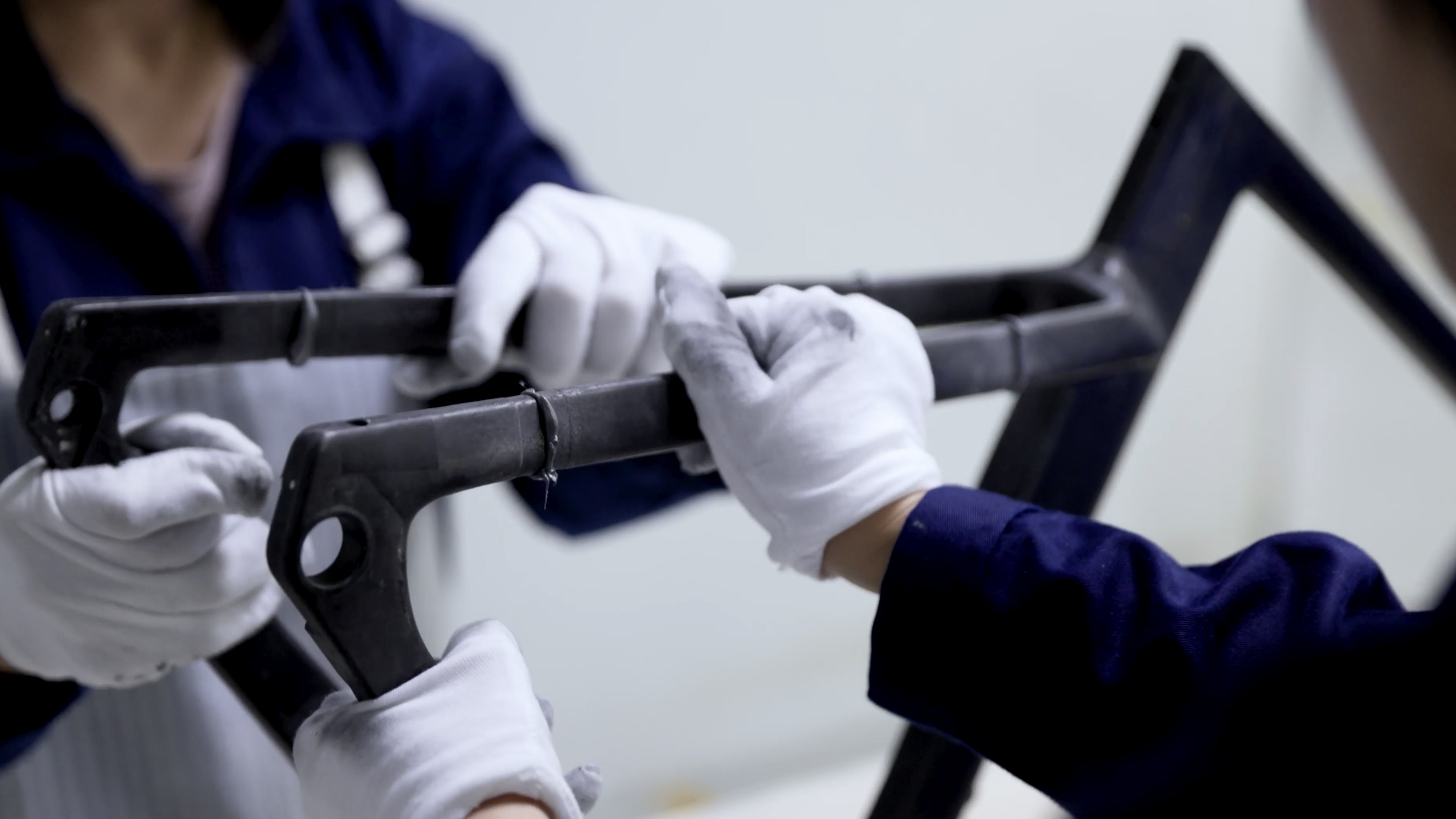 XDS Factory, raw carbon frame being assembled by workers