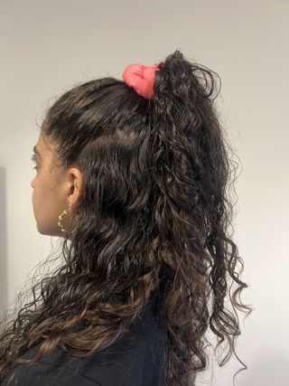 photo of Gabrielle Ulubay from the back with her hair half-up in a scrunchie