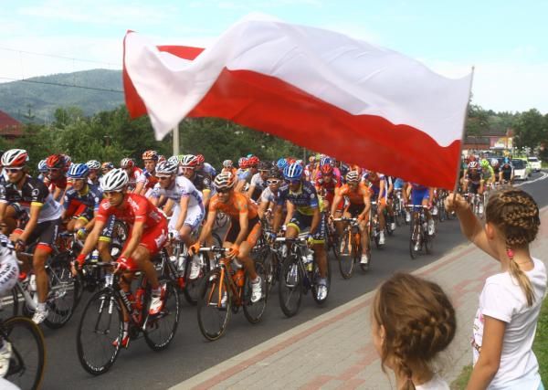 Polish fans fly their national colors for the peloton