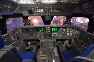 Space Center Houston’s mock space shuttle Adventure features a walkthrough interior crew cabin, including the forward flight deck pictured here, reproducing the commander and pilot stations.