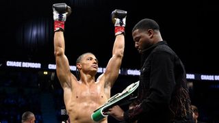 Misfits boxer Chase DeMoor raises his arms aloft after defending his Misfits boxing heavyweight title.