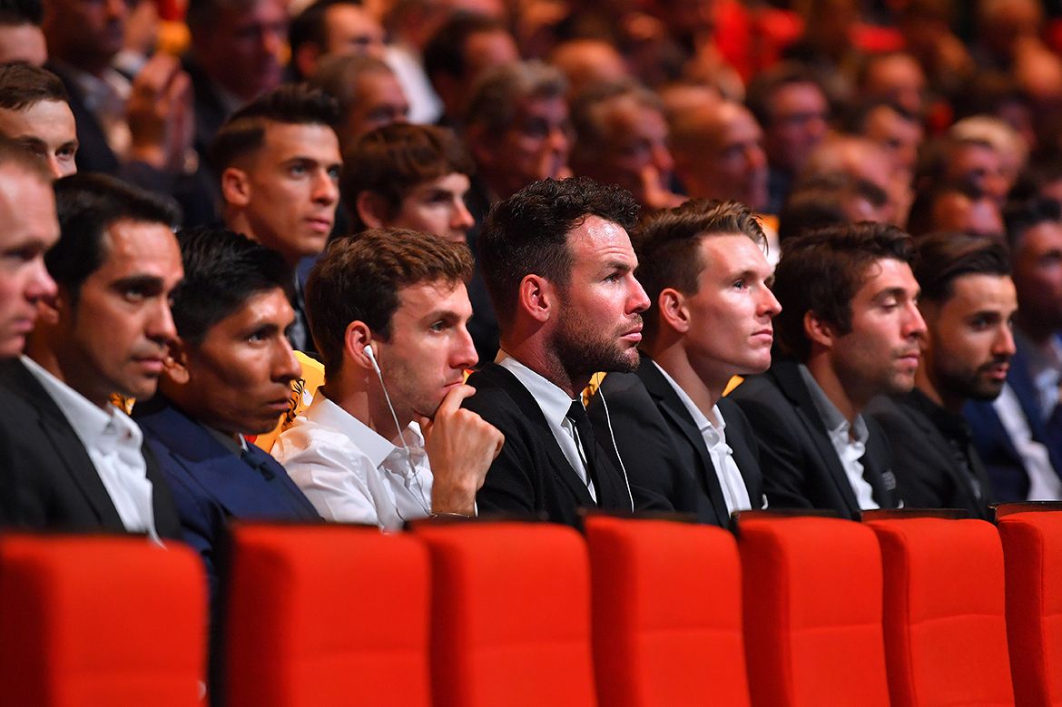 The riders sit next to each other as the route in unveiled