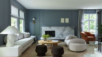 living room with blue walls and white sofas
