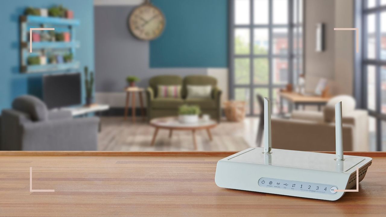 Blue living room out of focus in the background of a wooden counter top with a wifi router to support expert advice on the best place for a wifi router