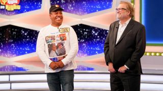 A contestant and Drew Carey smiling on The Price Is Right at Night