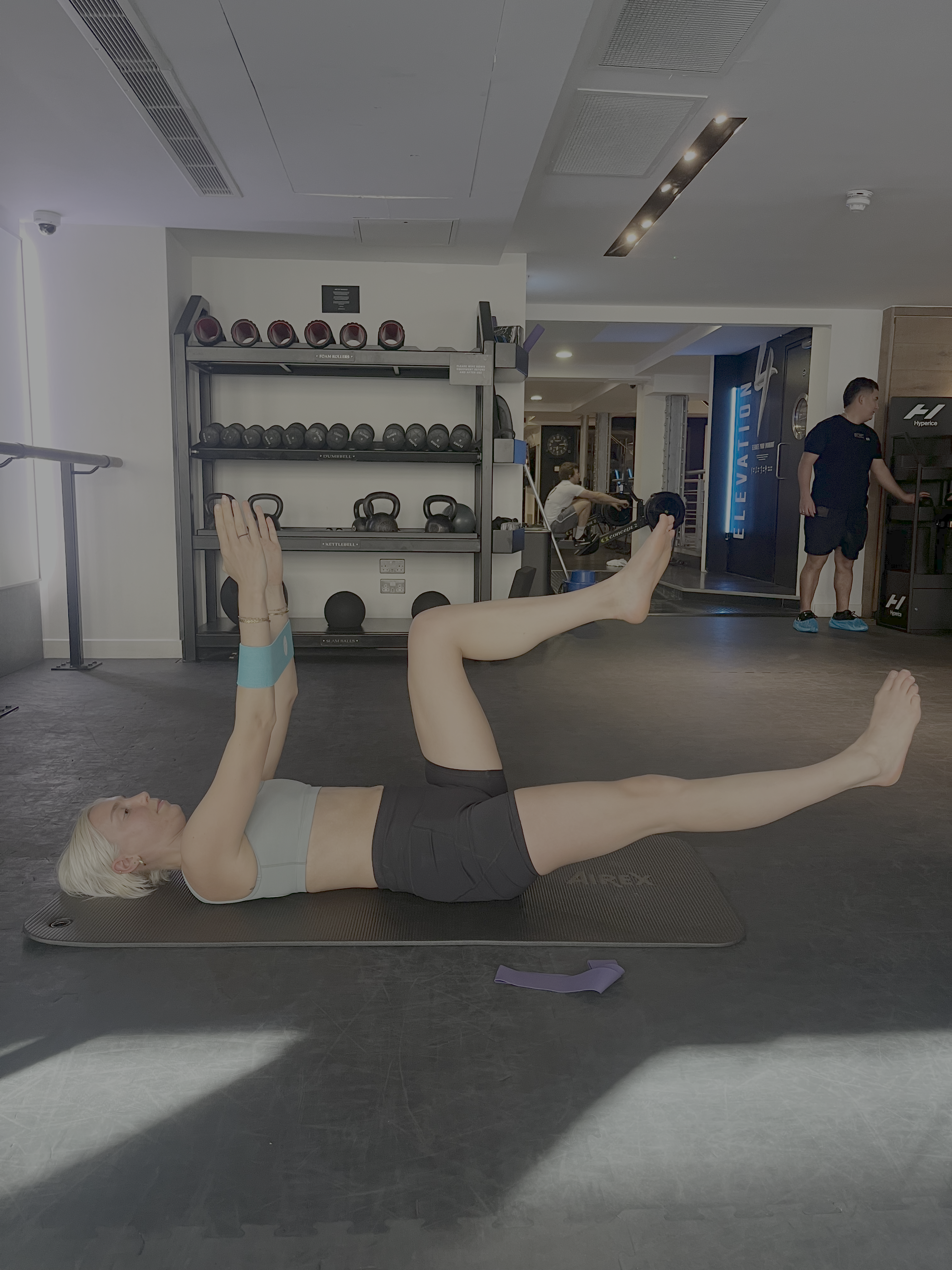 A woman doing a pilates core exercise in the gym