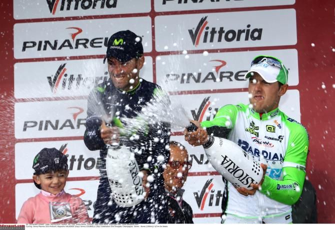 The podium sprays the crowd and photographers with champagne
