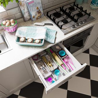 Kitchen drawer with colorful utensils organized with adjustable spacers