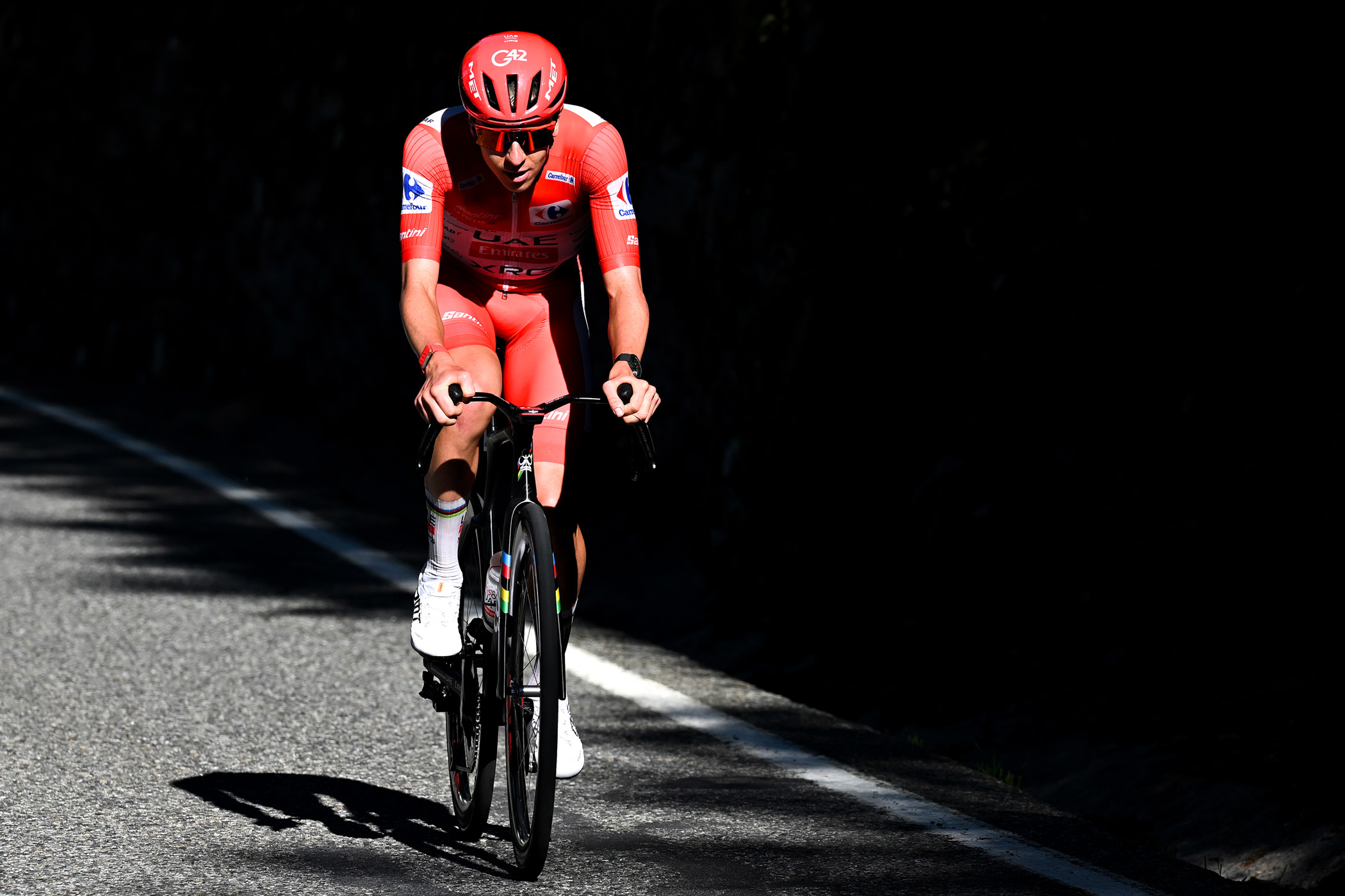 Tadej Pogačar races solo in the red jersey of the Vuelta a Espa&ntilde;a on stage 4 of the race in Andorra la Vella