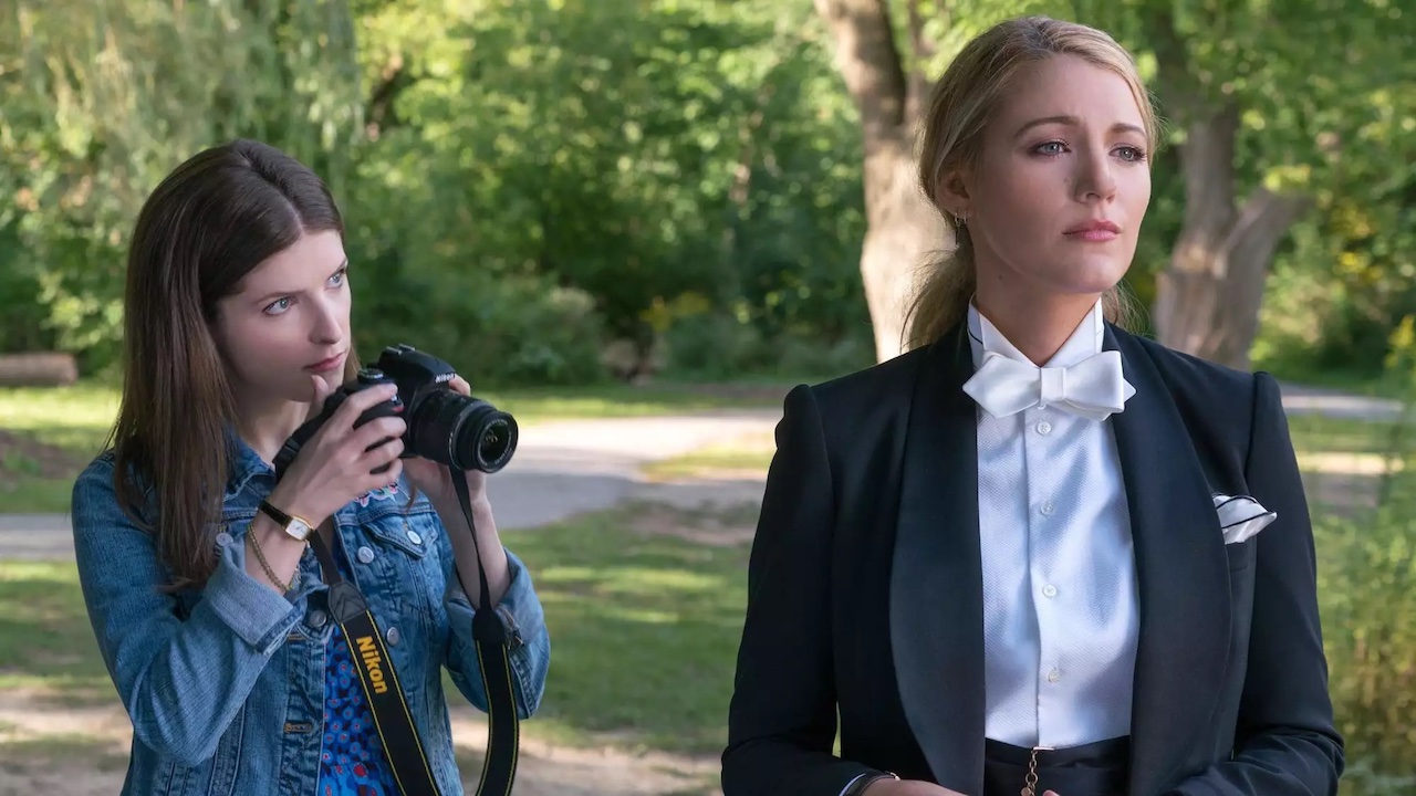 Anna Kendrick holding camera near tuxedoed Blake Lively in A Simple Favor