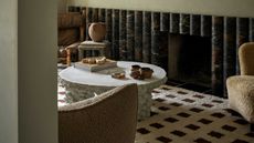 a modern living room with a coffee table and marble fluted wall