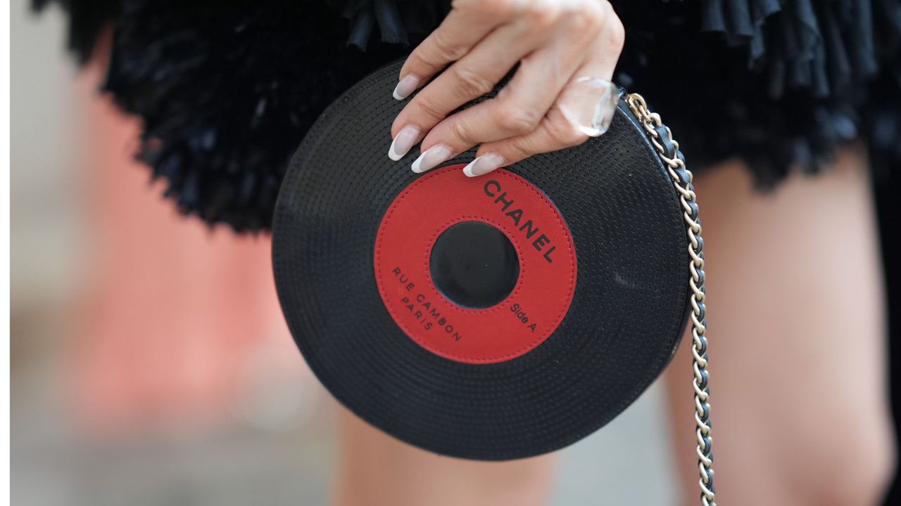 Woman wearing the Brazilian manicure at fashion week wearing a chanel disk bag