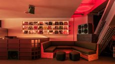 A neon-lit, high-fidelity record store and listening bar.