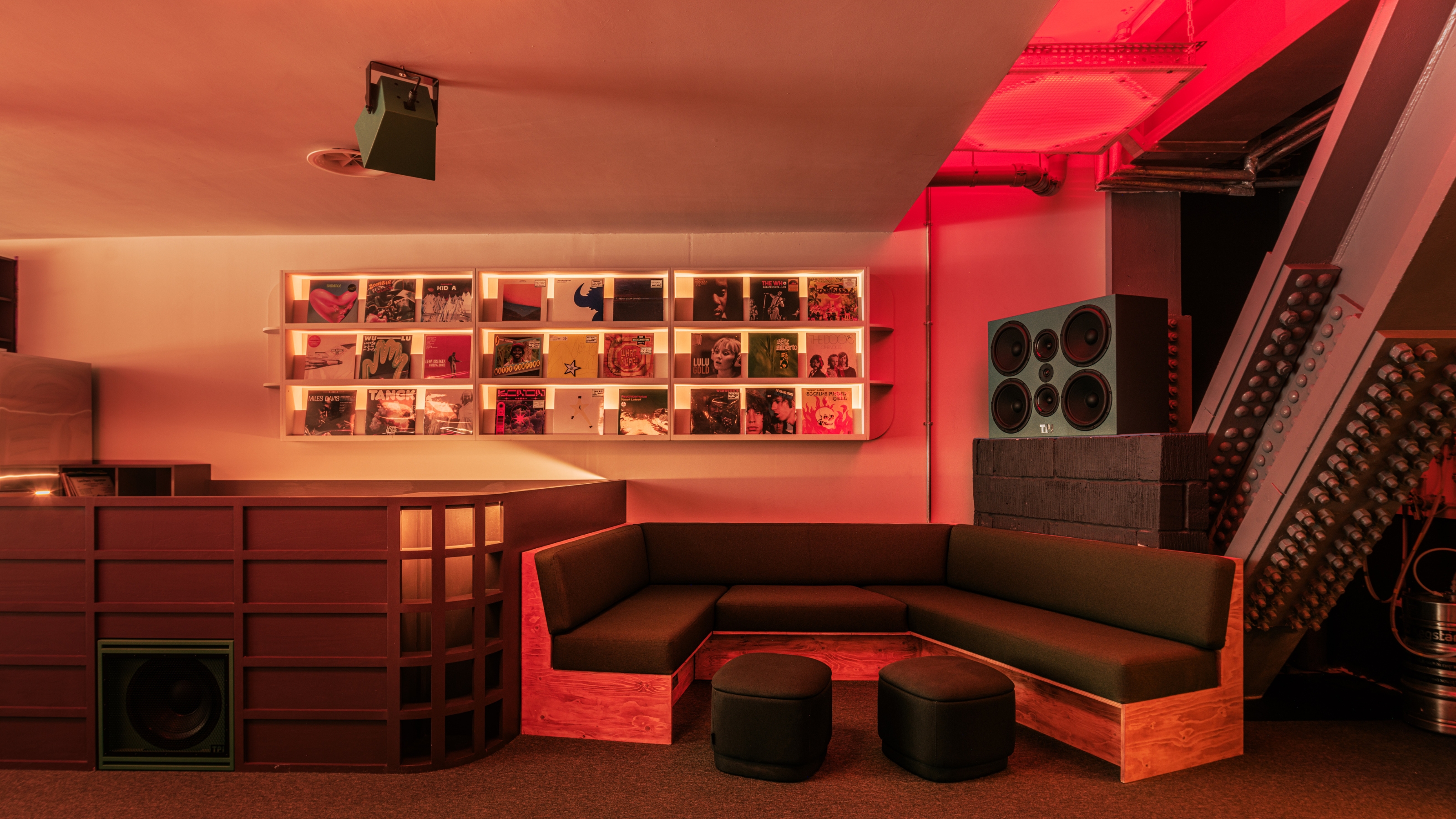 A neon-lit, high-fidelity record store and listening bar.