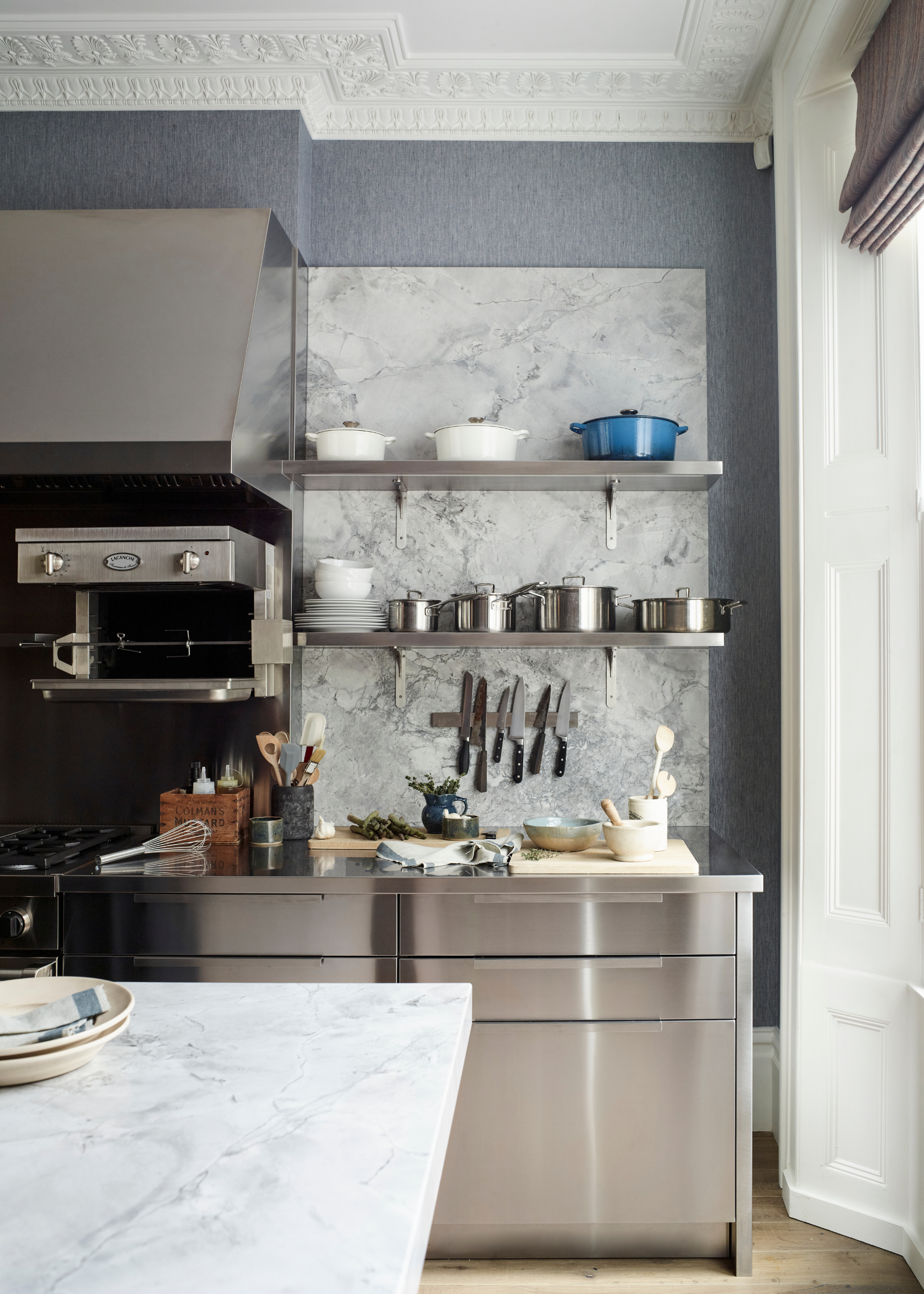 stainless steel kitchen with lots of professional chef equipment around