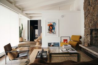 Art displayed in a living room with white walls