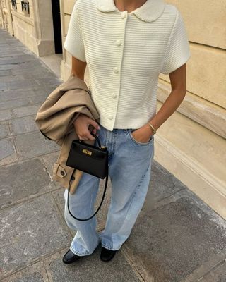 woman wearing white short-sleeve collared button-down sweater and jeans