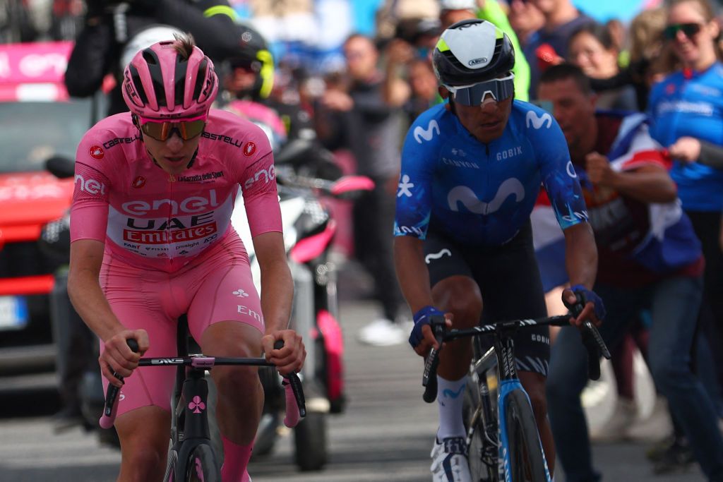 Pink jersey Team UAE's Slovenian rider Tadej Pogacar (L) rides past Team Movistar's Colombian rider Nairo Quintana to win the 15th stage of the 107th Giro d'Italia cycling race, 222km between Manerba del Garda and Mottolino on May 19, 2024. (Photo by Luca Bettini / POOL / AFP)