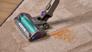 Shark PowerDetect cordless vacuum clearing dry lentils/rice from a carpet