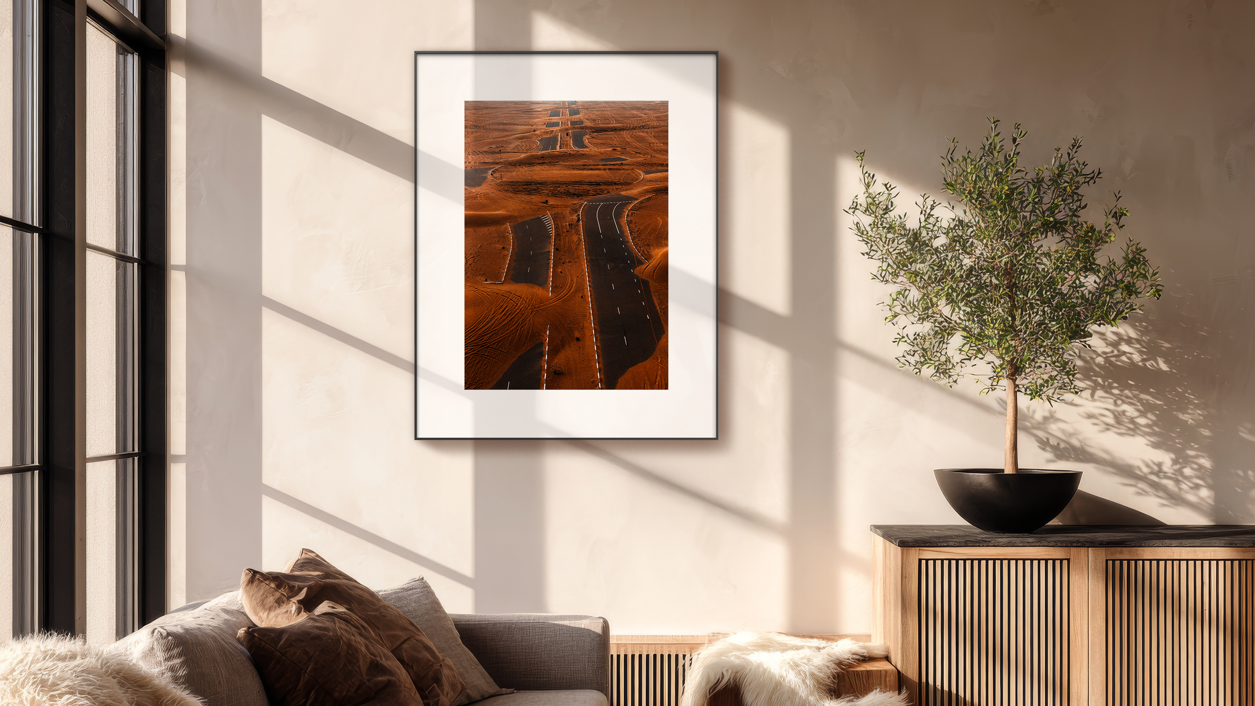 The Pocketbook InkPoster Tela on a wall near a window