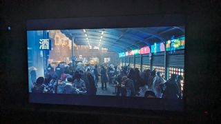 TCL 98P745 with Blade Runner 2049 market scene on screen