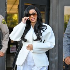cardi b wearing a white suit and black hair