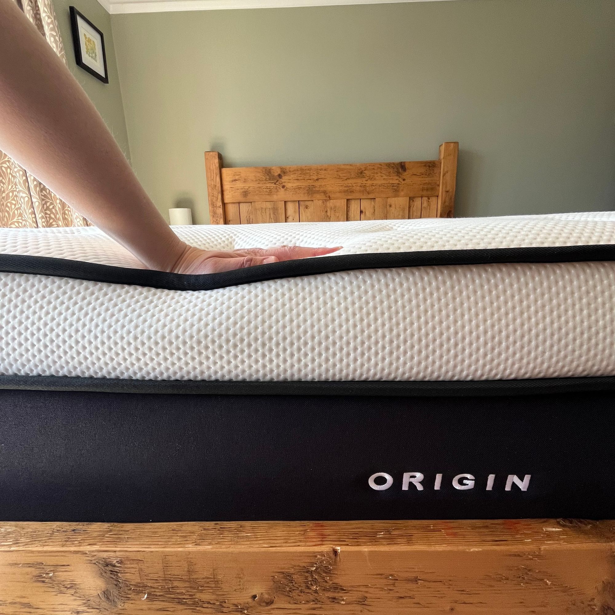using a hand to test the responsiveness of the Origin LumbarCloud mattress