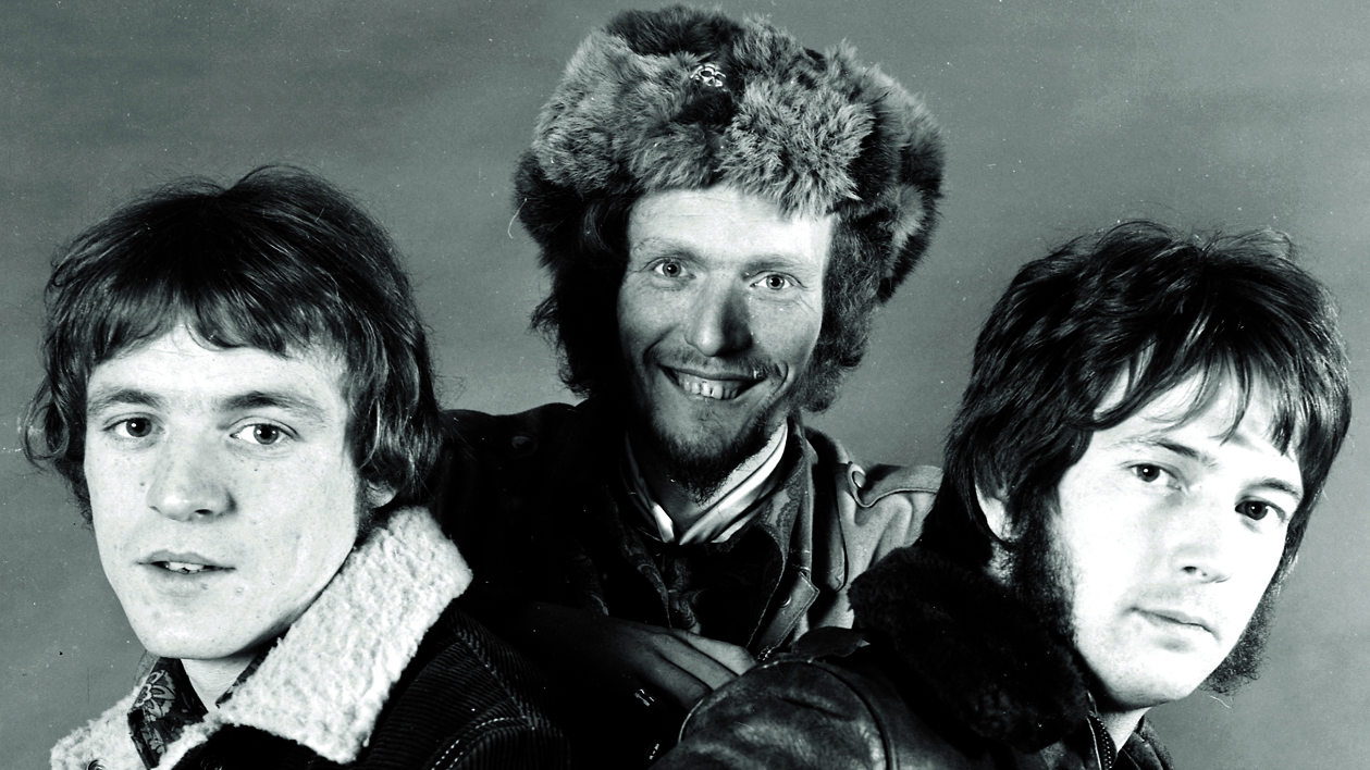 Jack Bruce, Ginger Baker and Eric Clapton of Cream, looking at the camera.