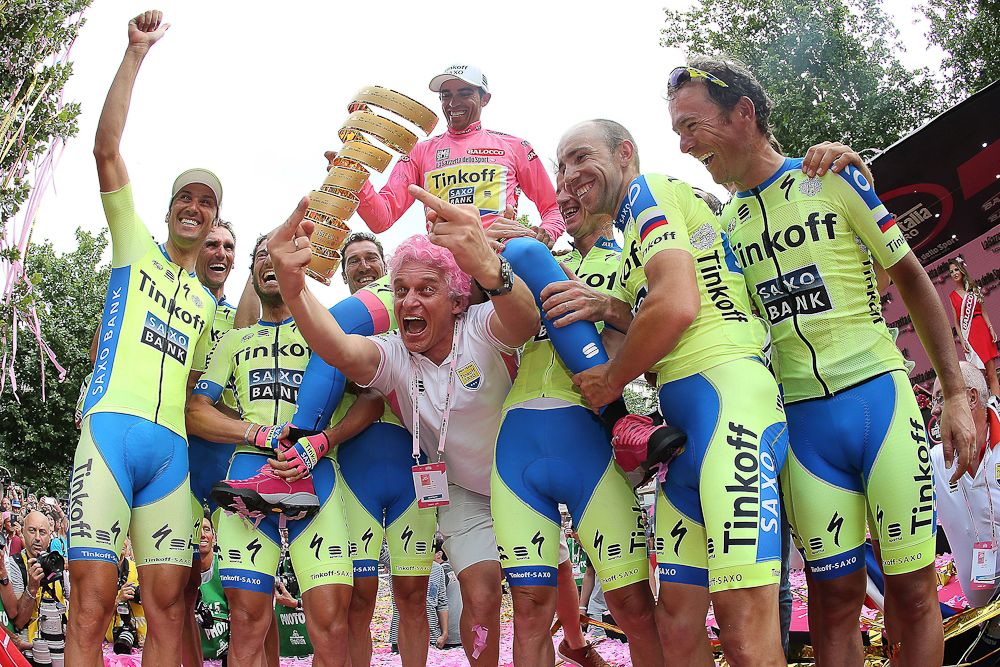 Alberto Contador celebrates with his Tinkoff-Saxo teammates and Russian businessman and team sponsor Oleg Tinkov on the podium after winning the 98th Giro d'Italia.