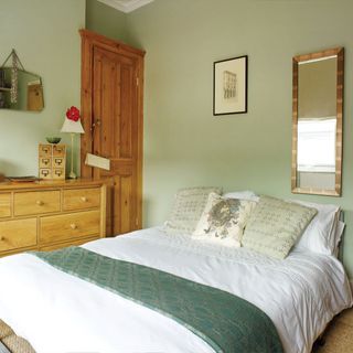 bedroom with green wall and cupboard