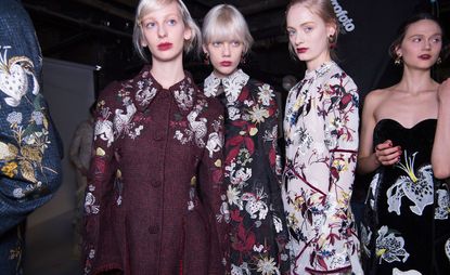 Female models in dark floral suits & dresses