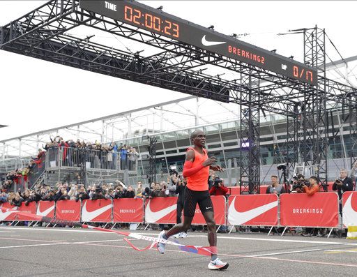 Olympic marathon champion Eliud Kipchoge crosses the finish line