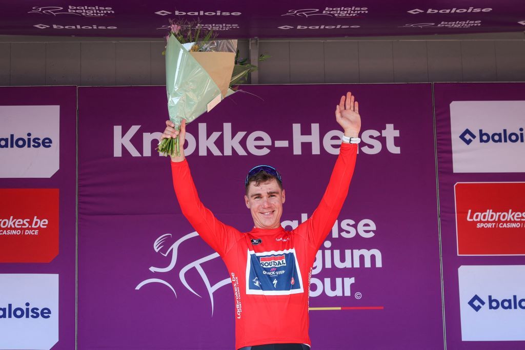 Soudal QuickSteps Dutch rider Fabio Jakobsen celebrates on the podium with the sprinters red jersey after winning the second stage of the Baloise Belgium Tour cycling race from Merelbeke to KnokkeHeist 1757km on June 15 2023 Photo by DAVID PINTENS Belga AFP Belgium OUT Photo by DAVID PINTENSBelgaAFP via Getty Images