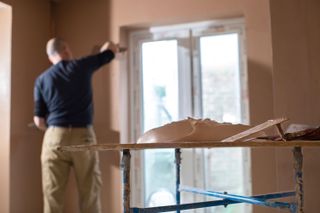 man plastering a wall