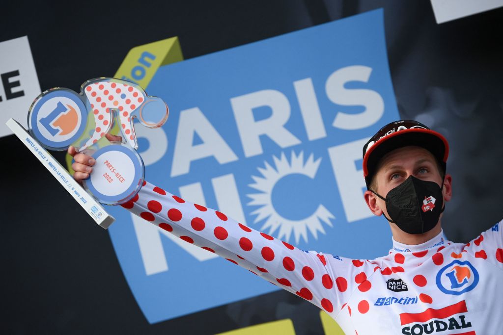 Lotto Soudals British rider Matthew Holmes celebrates his best climbers polka dot jersey on the podium at the end of the the 1st stage of the 80th edition of the Paris Nice cycling race 160 km between ManteslaVille and ManteslaVille on March 6 2022 Photo by FRANCK FIFE AFP Photo by FRANCK FIFEAFP via Getty Images