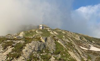 On Mountain Hut, exterior view from a distance, with cloud cover