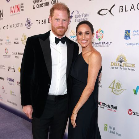 Prince Harry and Meghan Markle posing on a red carpet