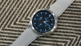 A Samsung Galaxy Watch 4 Classic on a patterned surface