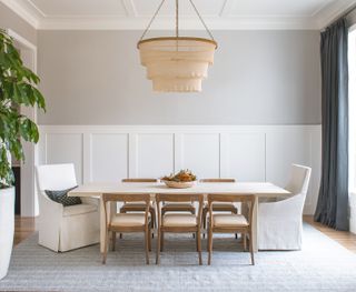 neutral dining room with grey walls and white chairs