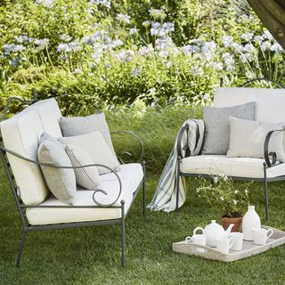 garden sofa set with cushions potted plants with cup of tea cupboard