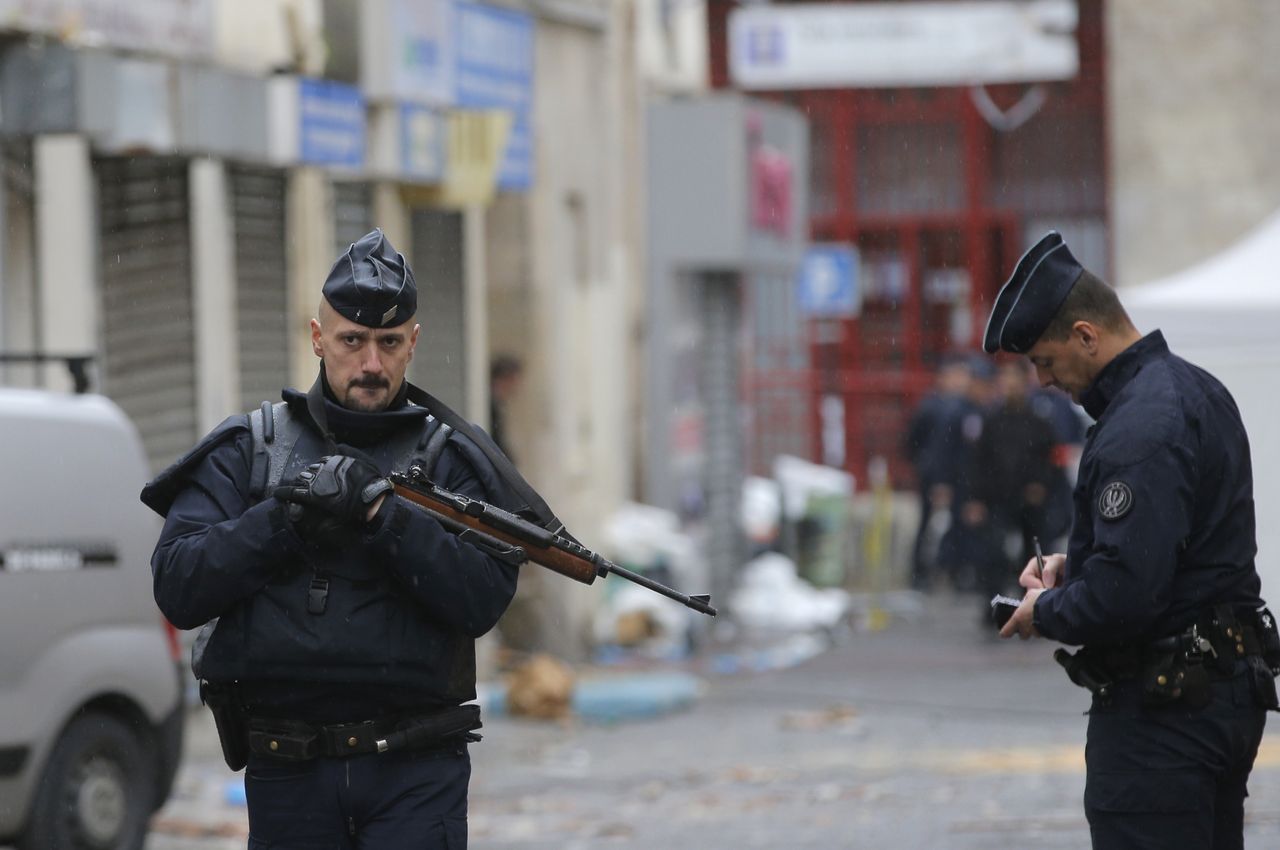 French police guard the raid site.