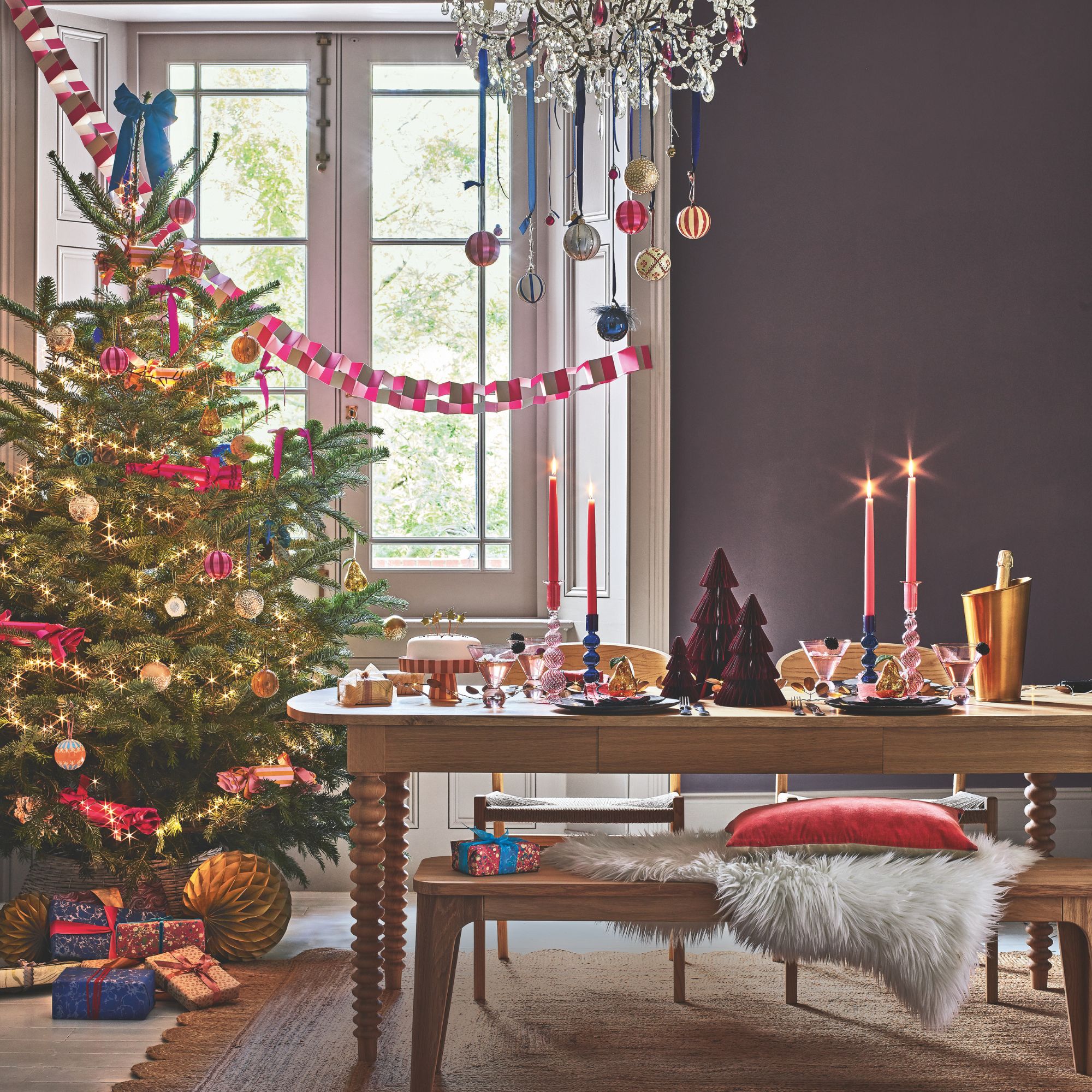 Christmas dining room with a christmas tree on the left and a dining table to the right