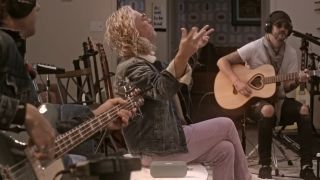 The member of collective soul sitting in chairs recording a song