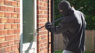 Burglar breaking into a home