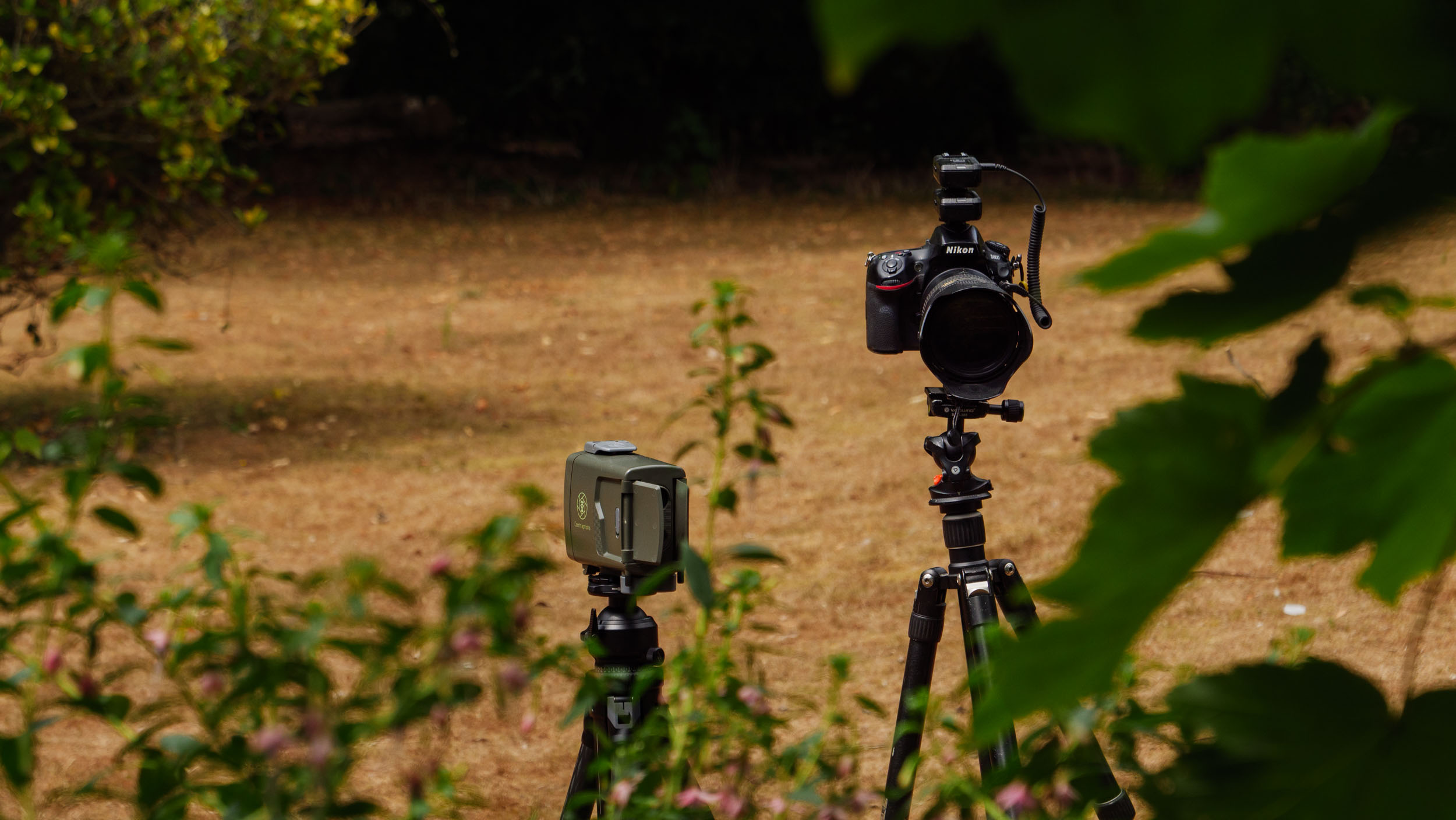 Camtraptions Camera Trap device  outdoors alongside a Nikon DSLR camera