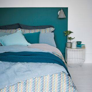 Blue painted bedroom and headboard