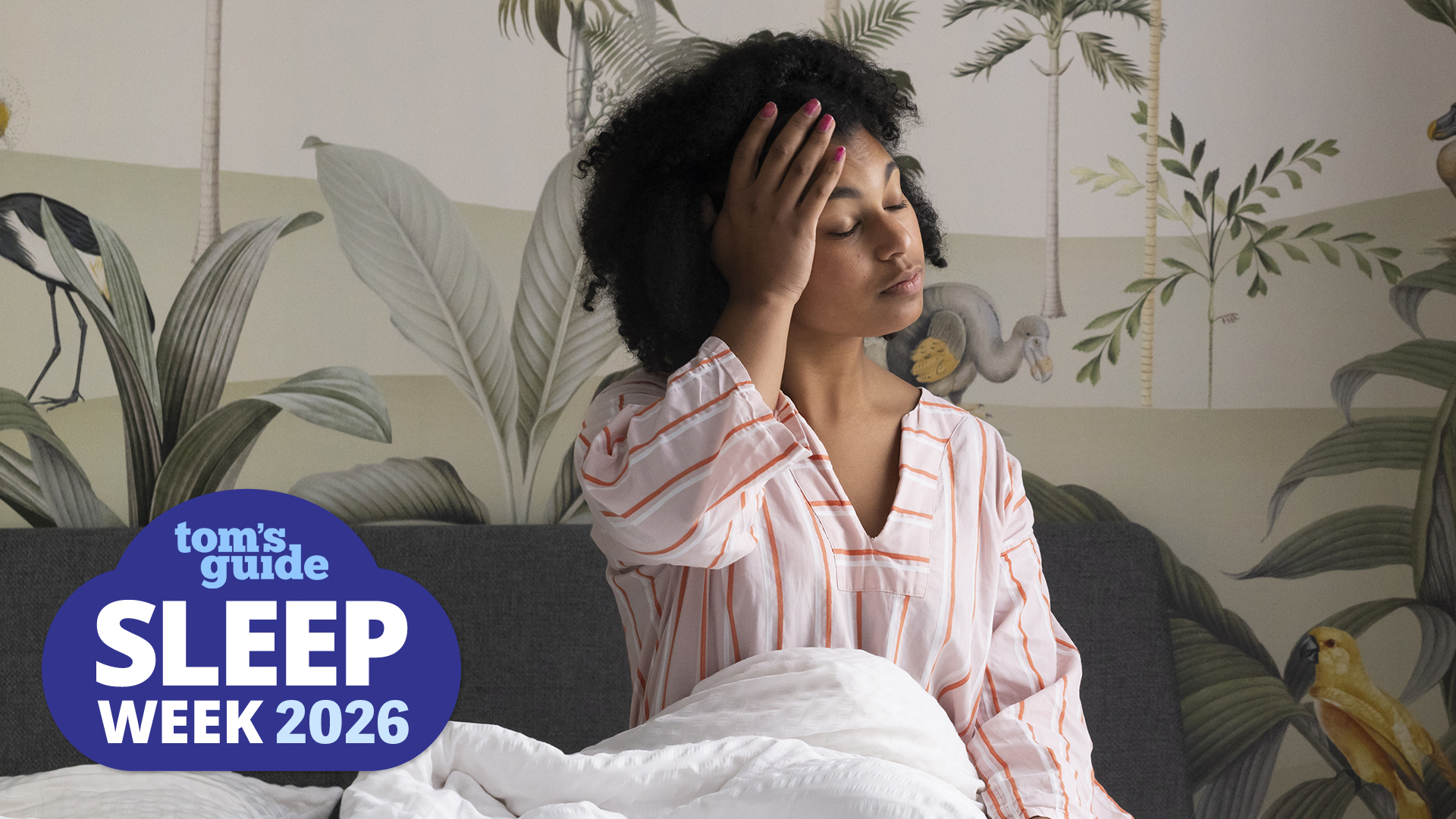 A woman sits up in bed with her hand on her forehead, looking exhausted and like she hasn't had any sleep. In the bottom left corner is a Tom's Guide Sleep Week 2026 logo