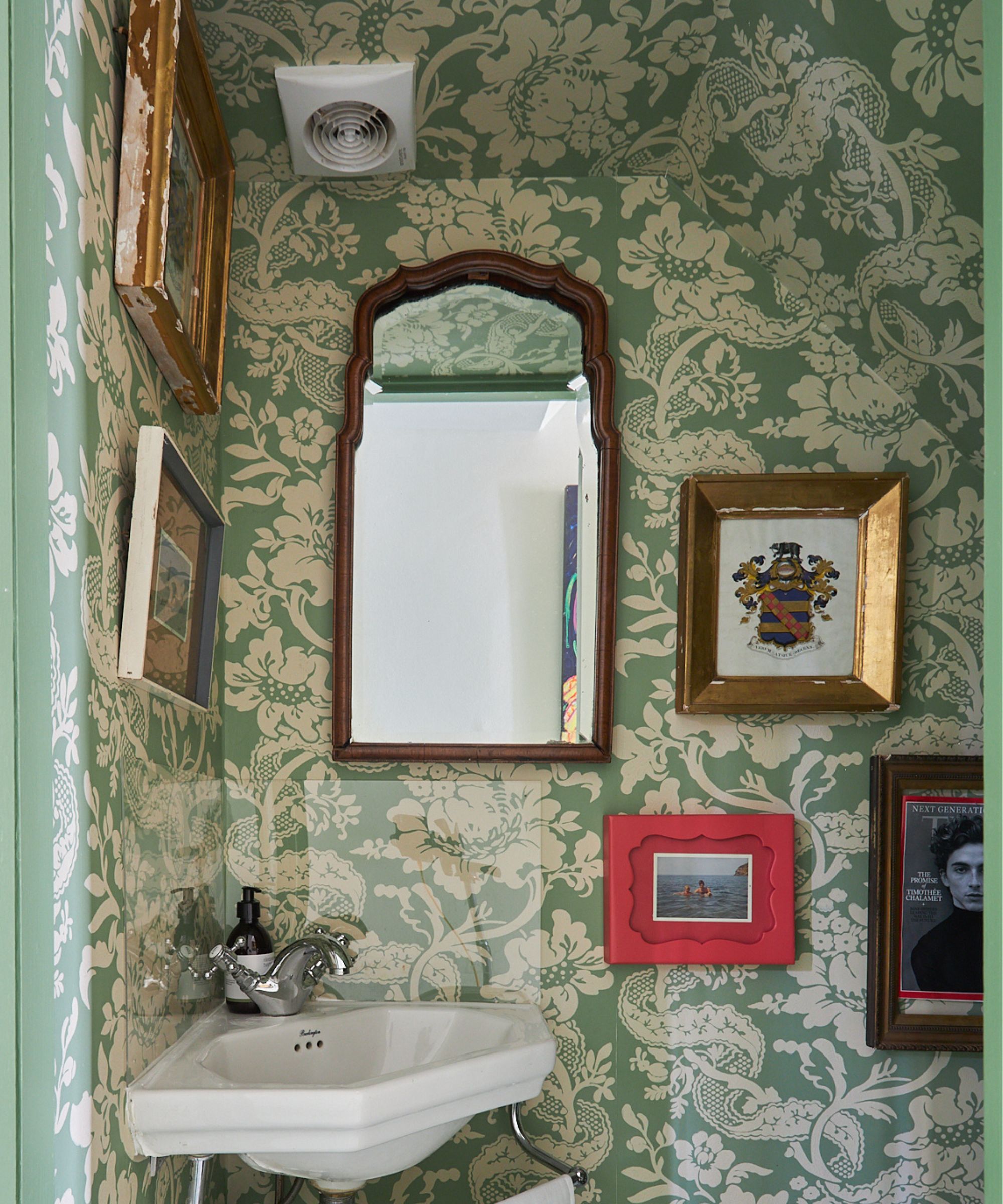 farrow and ball green floral wallpapered tiny bathroom with wallpapered ceiling