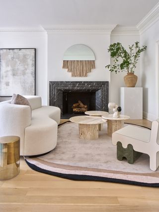 A family living room with round rug and neutral and pastel furniture
